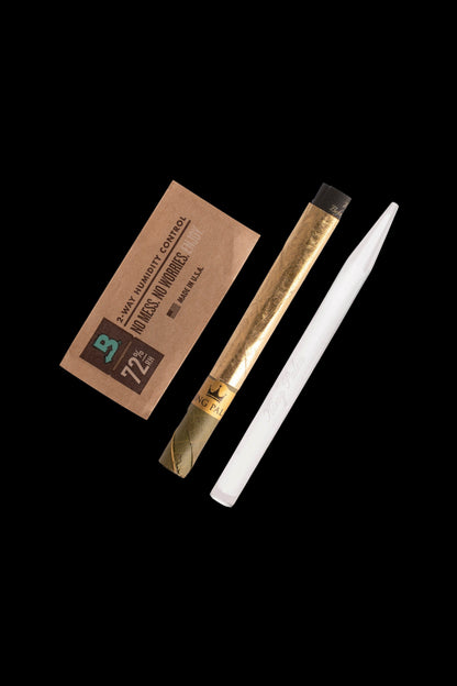 Two cannabis blunt wraps and a humidity control pack on a black background.