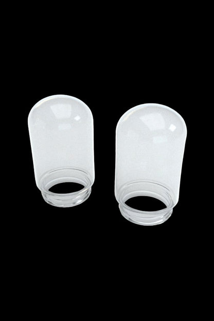 Two clear, empty glass jars with screw-on lids, likely for cannabis storage.