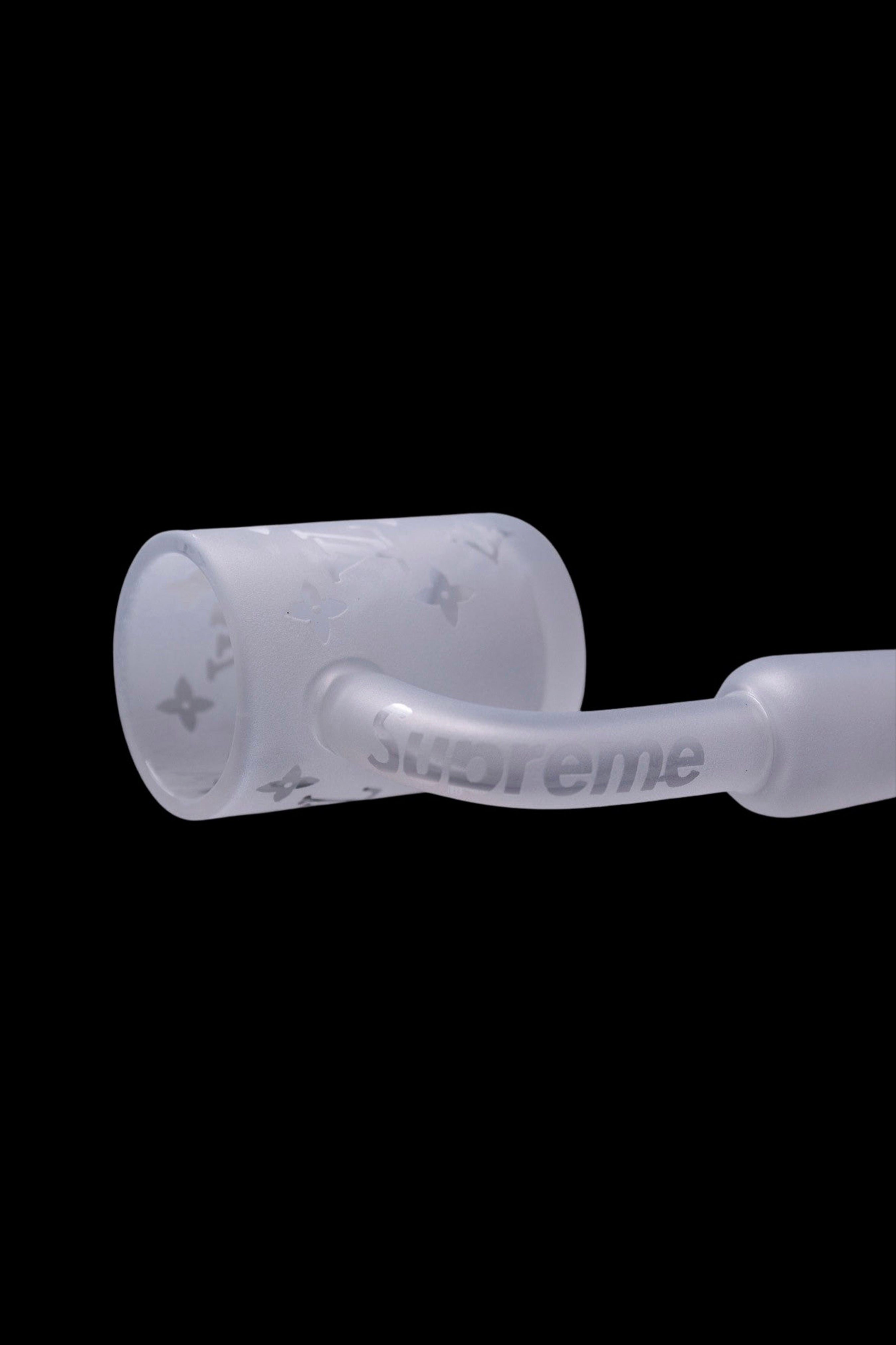 White glass pipe with "Supreme" logo, isolated on black.