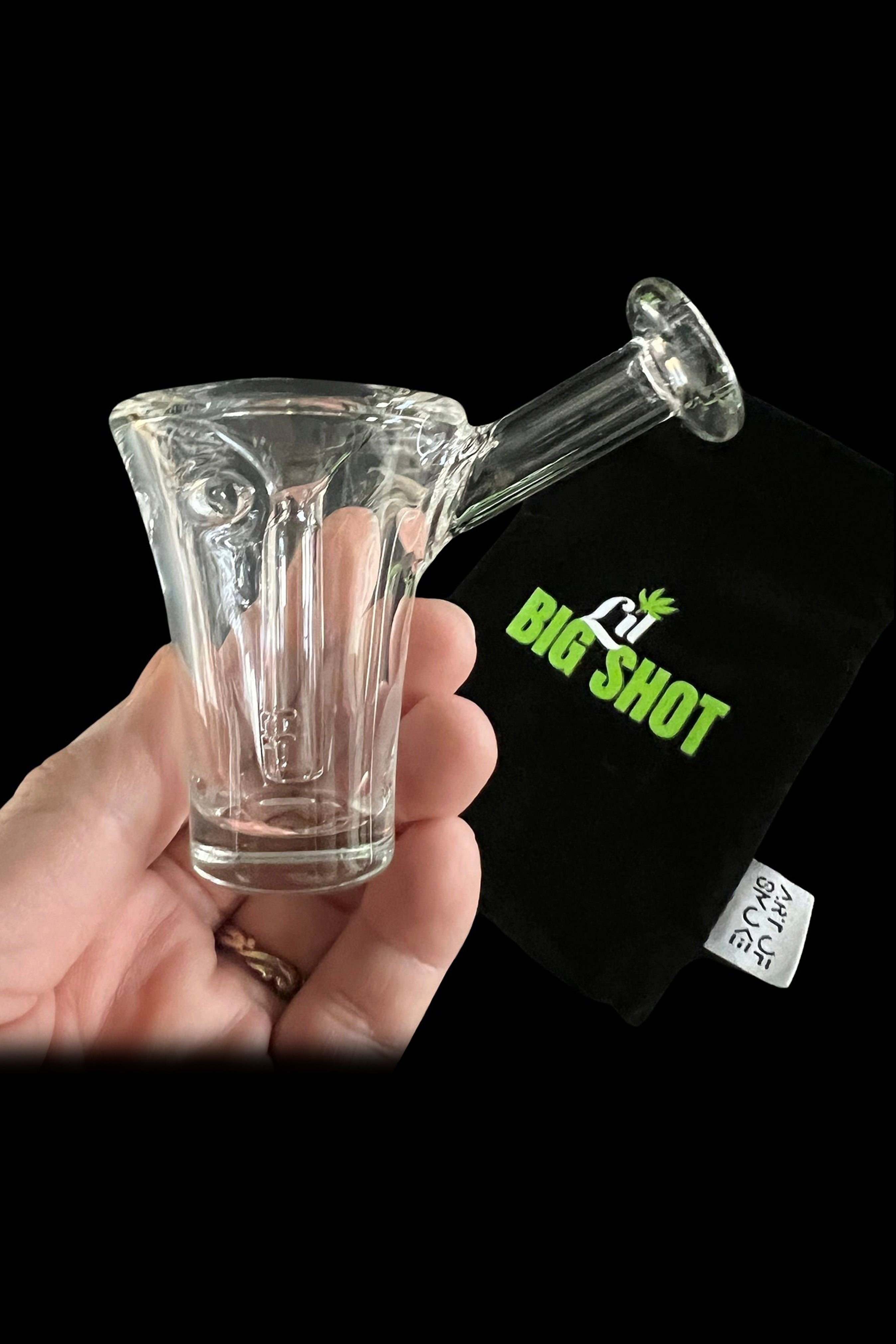 Clear glass bubbler pipe with textured design, displayed with branded packaging.