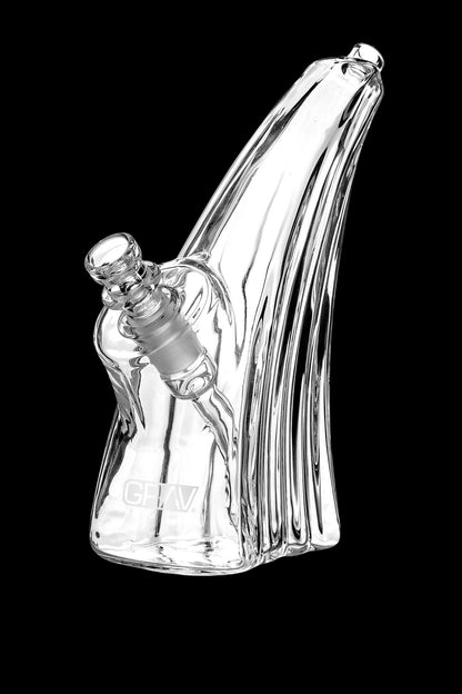 Clear glass water pipe (rig) with intricate vertical ribbing and a removable bowl piece.