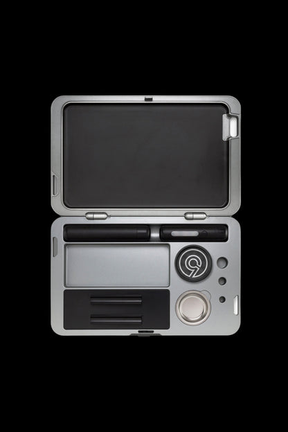 Silver cannabis kit with open case displaying pen, cartridge, and storage compartments.