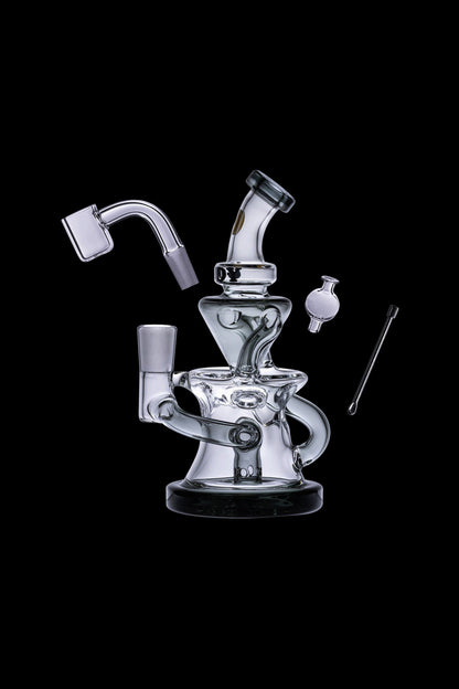 Clear glass dab rig with accompanying nail, carb cap, and dab tool, isolated on a black background.