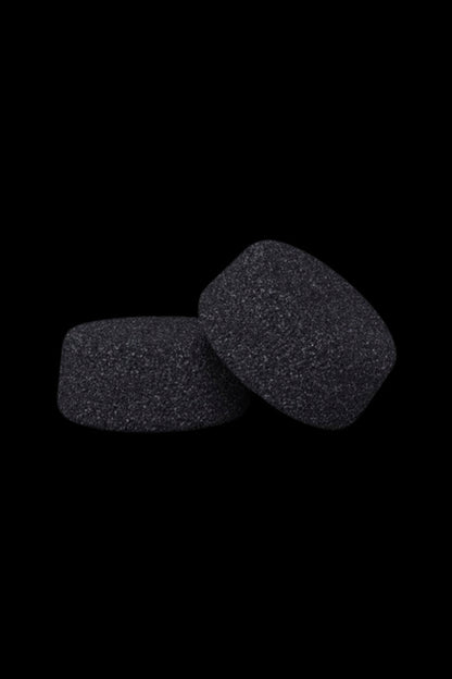 Two dark, textured foam filter replacements against a black background.
