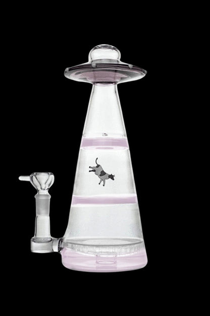 Pink glass water pipe shaped like a UFO with a cow illustration.