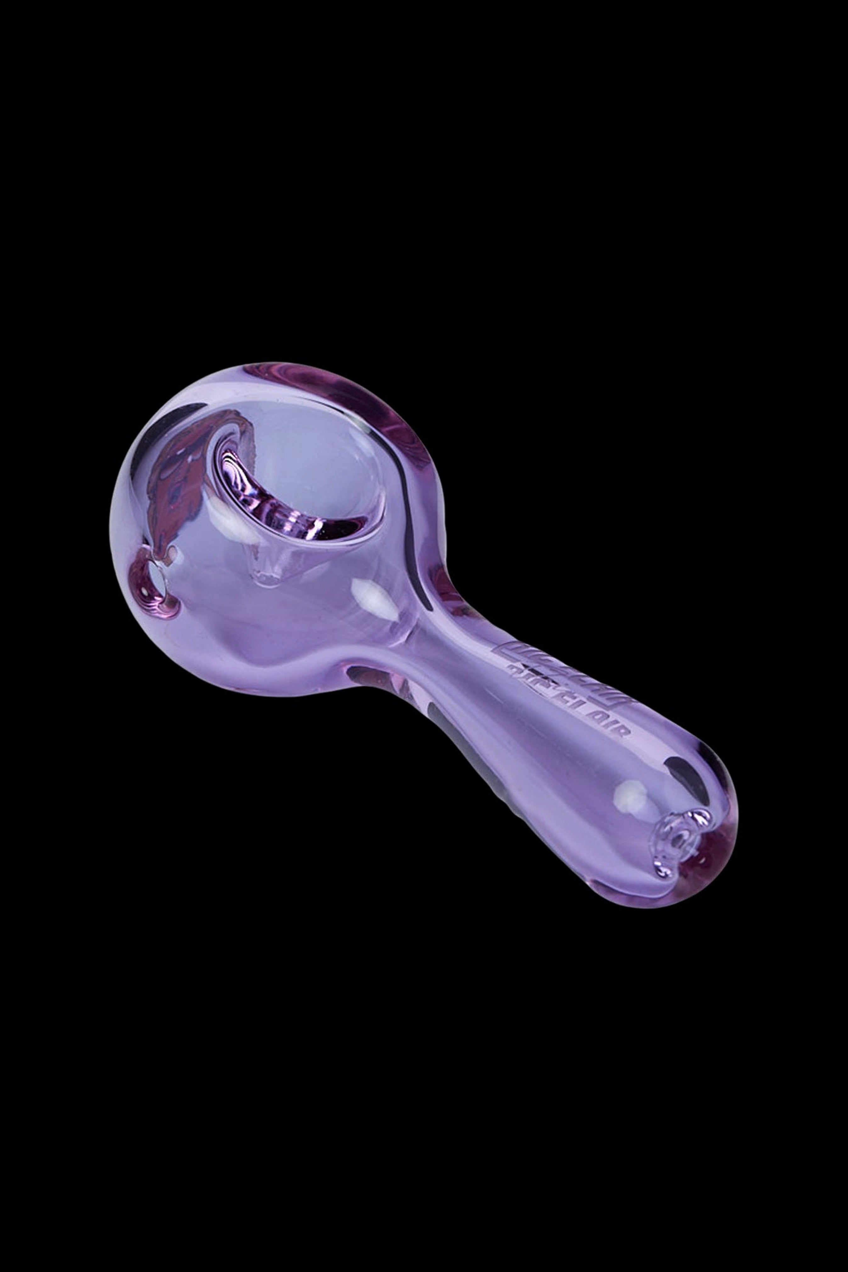 Purple glass smoking pipe on a black background.