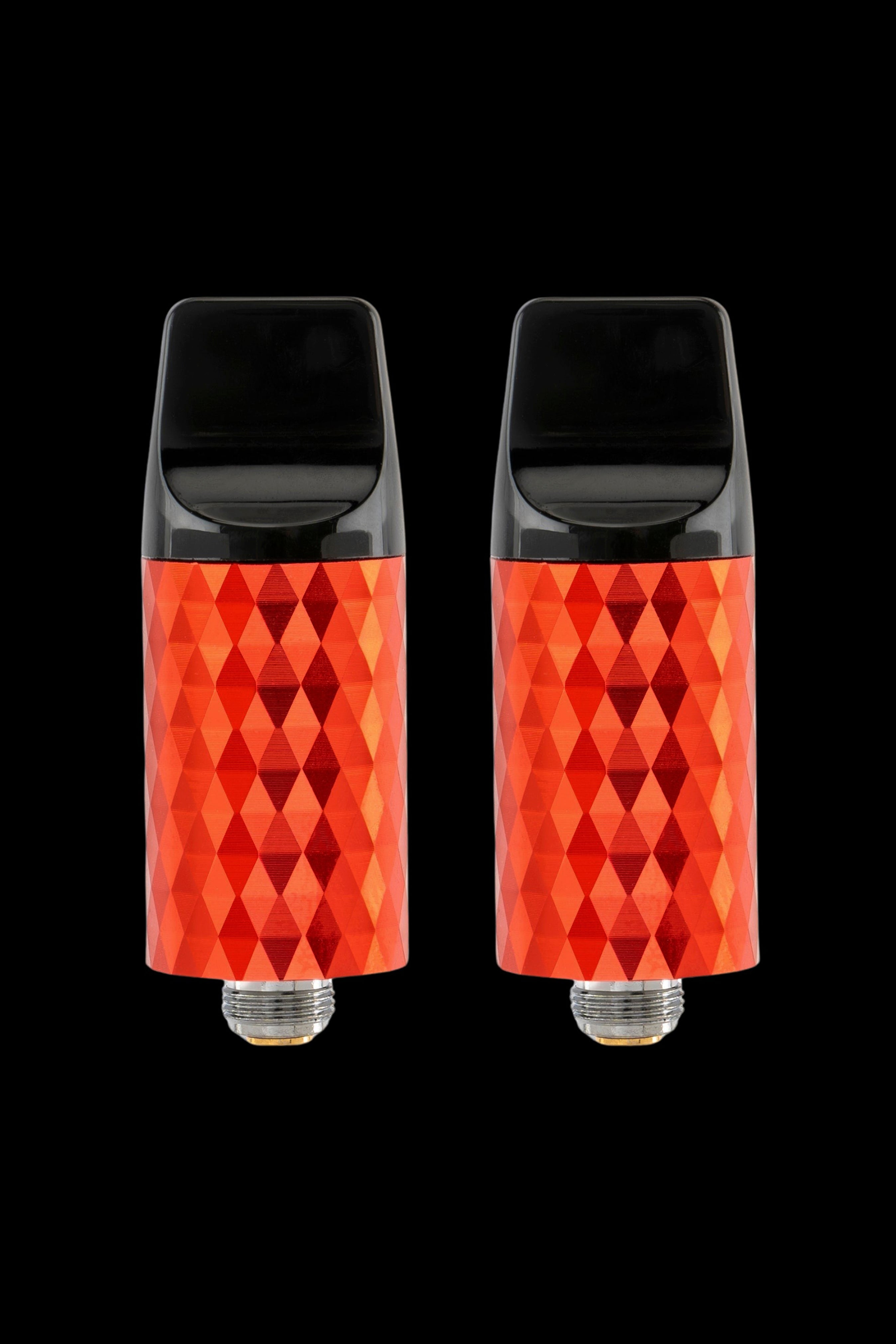 Two red, diamond-patterned cannabis vape cartridges against a black background.
