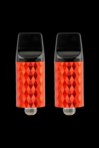 Two red, diamond-patterned cannabis vape cartridges against a black background.