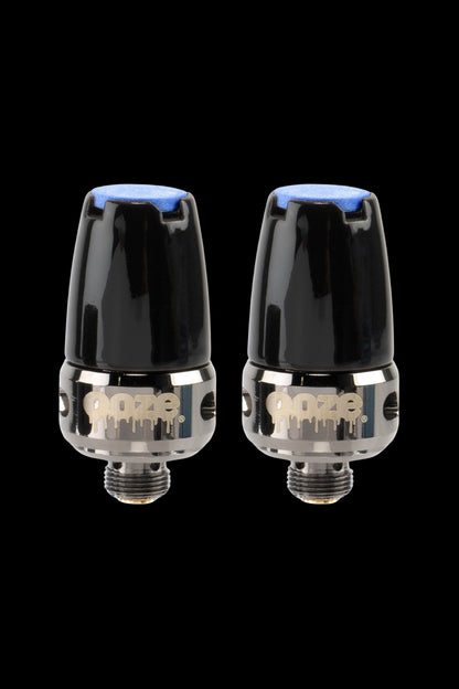 Two Dynavap M cannabis vaporizers against a black background.