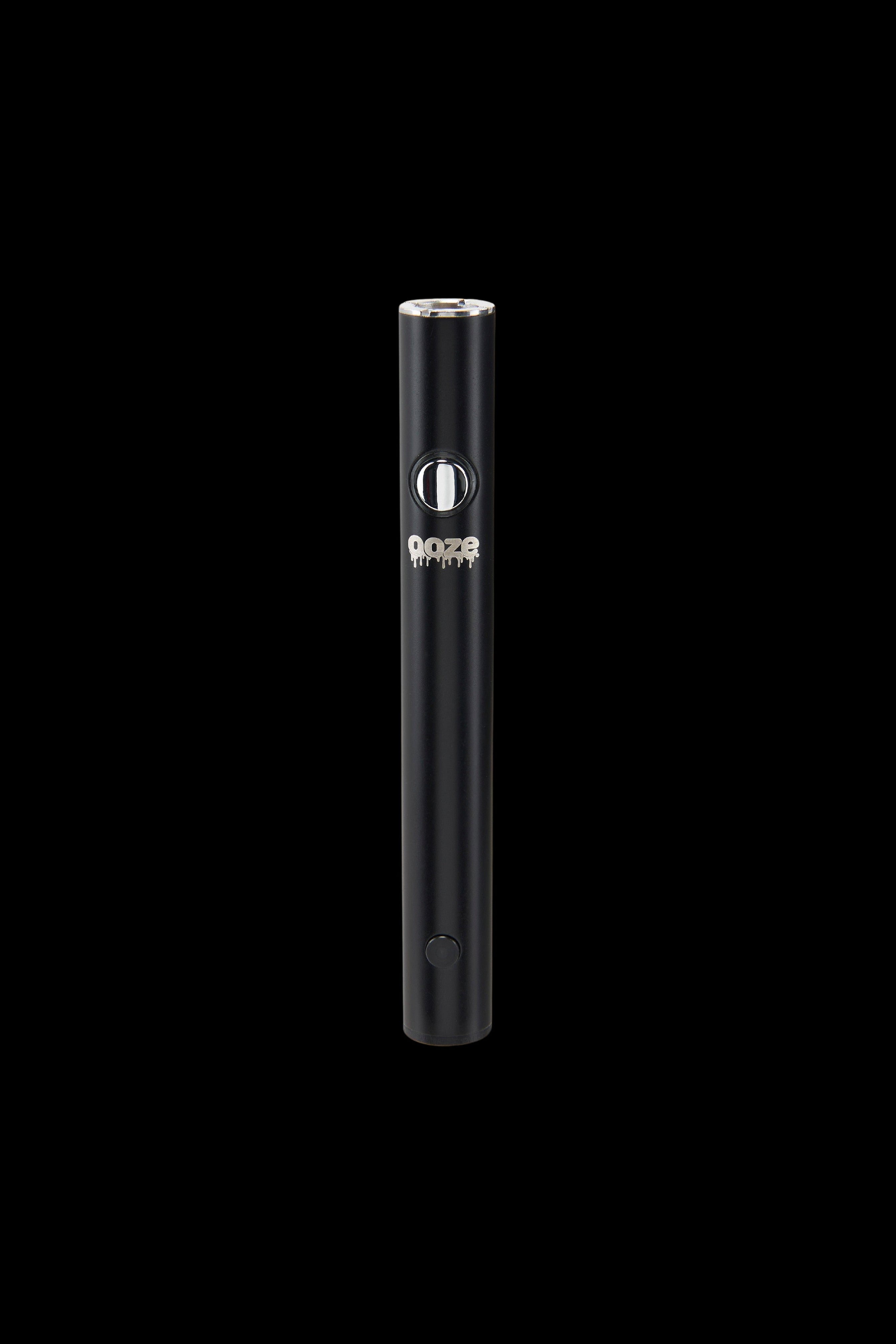Black cannabis vape pen with “ooze” branding against a black background.