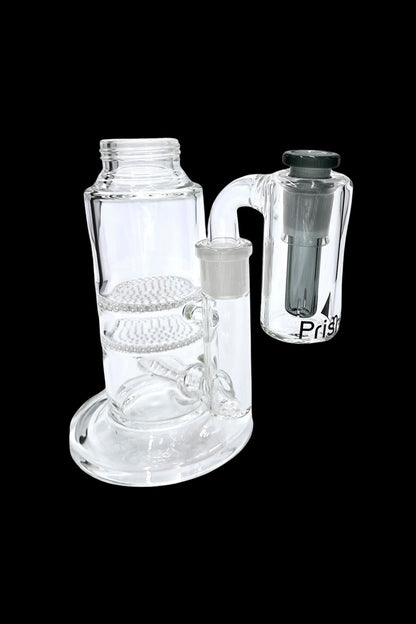 Glass bubbler water pipe with a removable downstem, isolated on a black background.