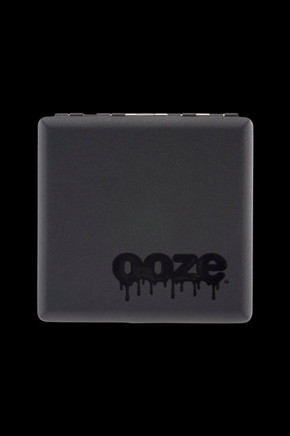 Top-close view of a matte black Ooze Joint Case with its dripping logo centered near the bottom against a black background.