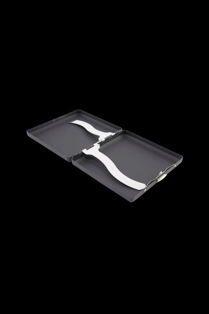 Angled close-up of an open black Ooze Joint Case showing its curved silver spring clip across the two interior panels.