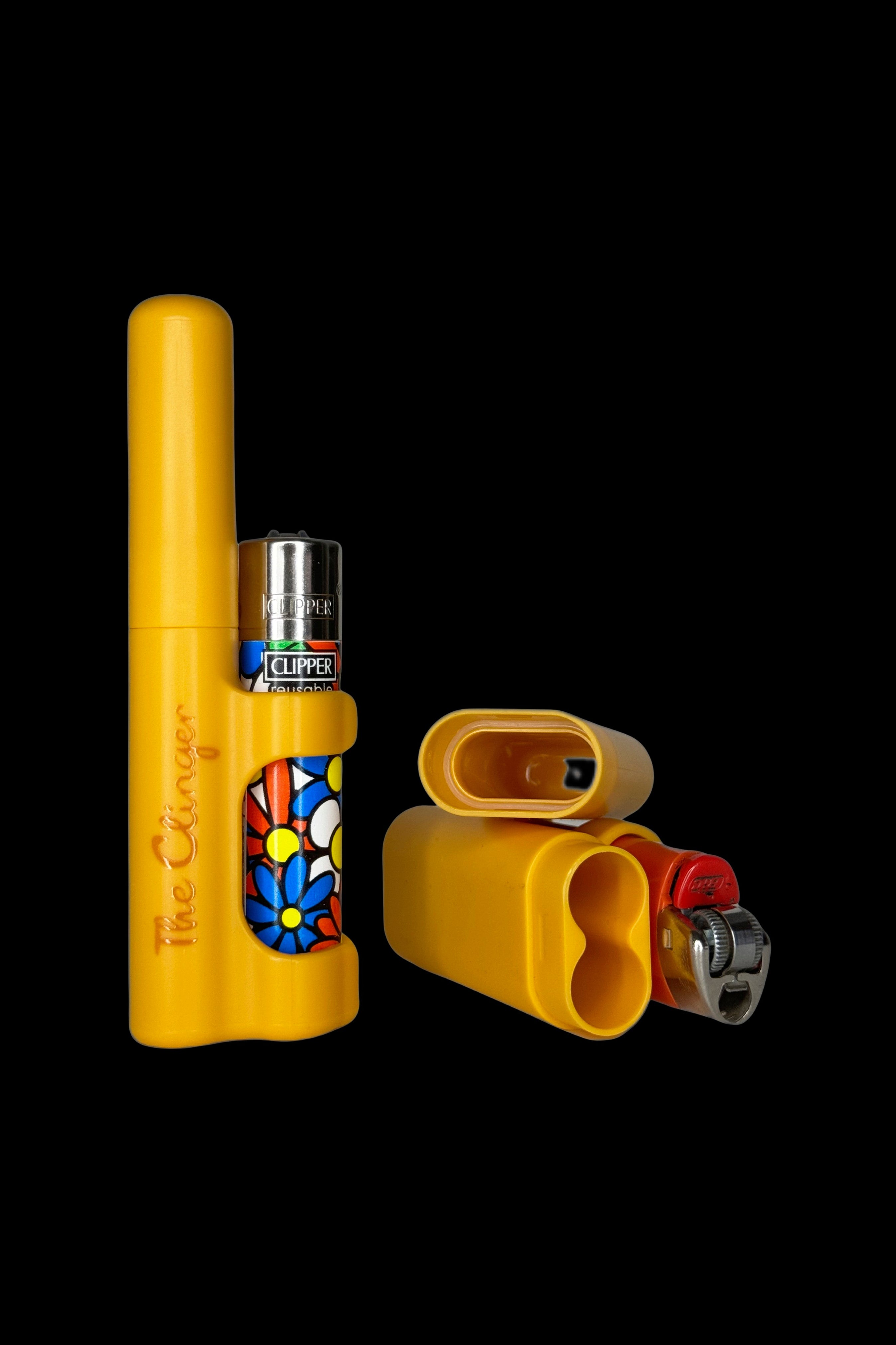 Yellow cannabis one-hitter pipe with a lighter and grinder inside, featuring a colorful flower design.