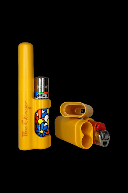 Yellow cannabis one-hitter pipe with a lighter and grinder inside, featuring a colorful flower design.