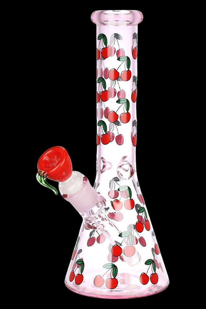 Pink glass bong decorated with red cherries against a black background.