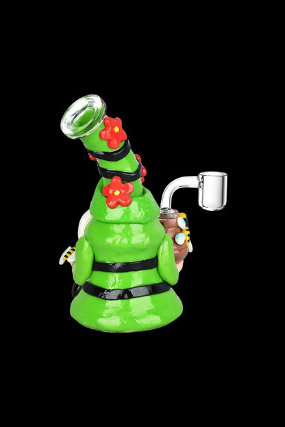 Green glass rig with floral accents and a quartz banger.