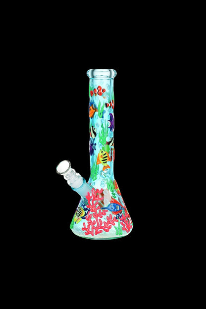 A colorful glass water pipe decorated with an underwater scene of coral and fish.