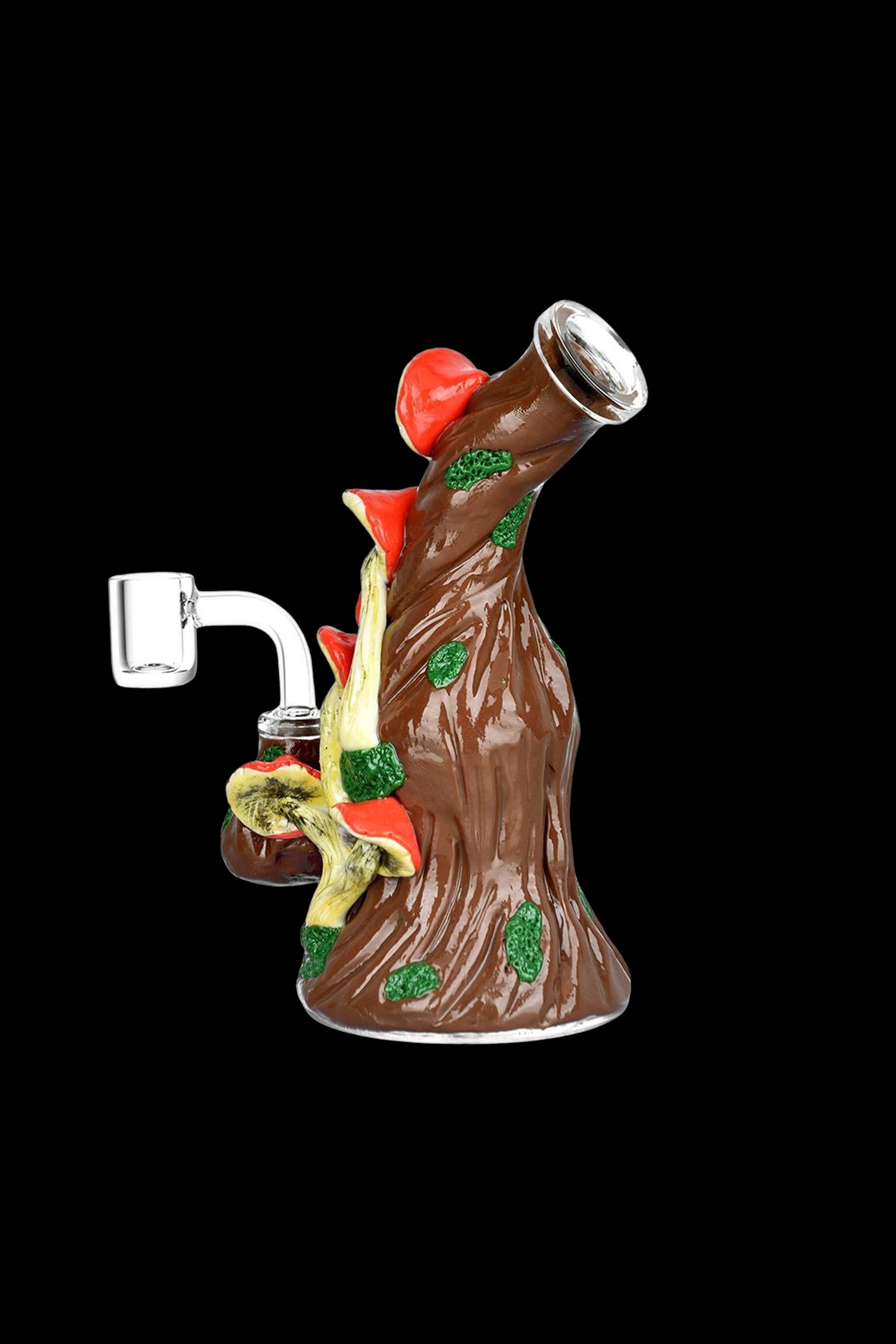 Hand-blown glass rig shaped like a tree with colorful mushrooms, featuring a quartz banger for cannabis concentrates.