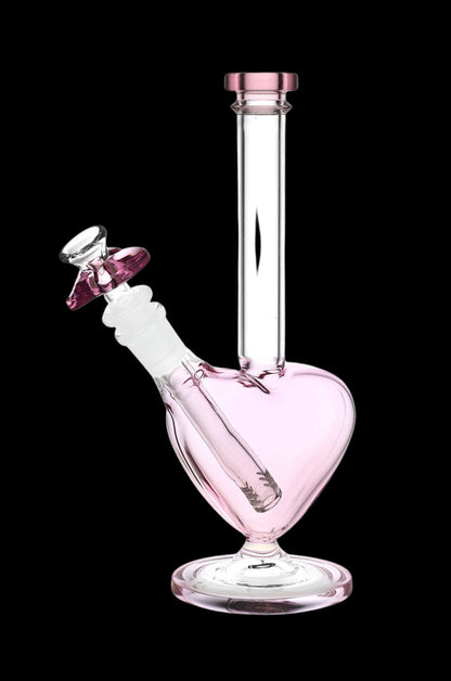 Pink glass water pipe (bong) with floral etching, isolated on a black background.