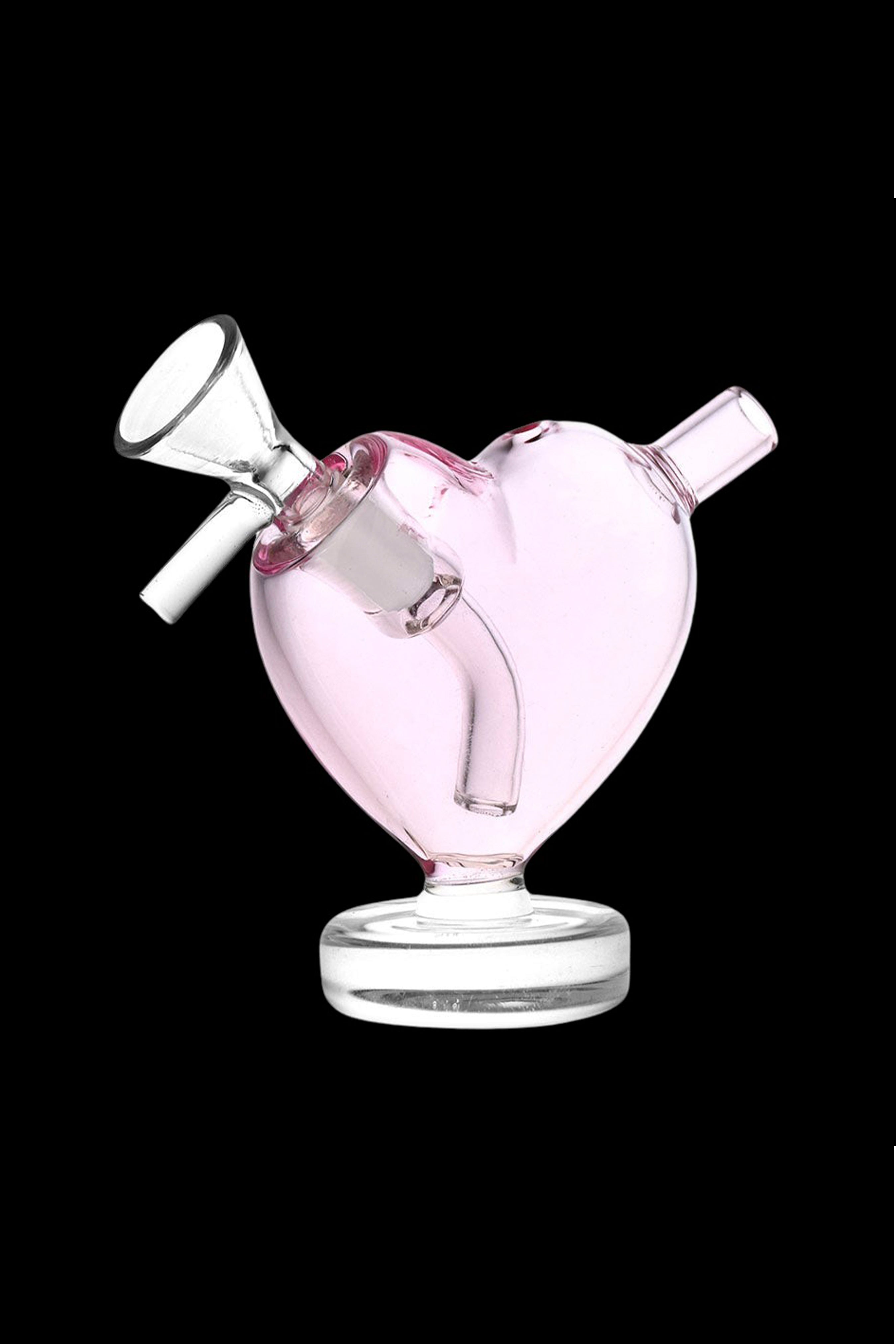 Pink heart-shaped glass bubbler for smoking, with a bowl and mouthpiece.