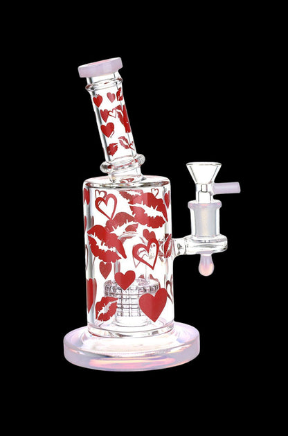 Glass water pipe decorated with red hearts and lips.