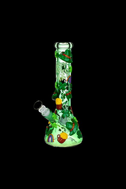 Green glass water pipe decorated with St. Patrick's Day themed imagery, including clovers, hats, and a pot of gold.