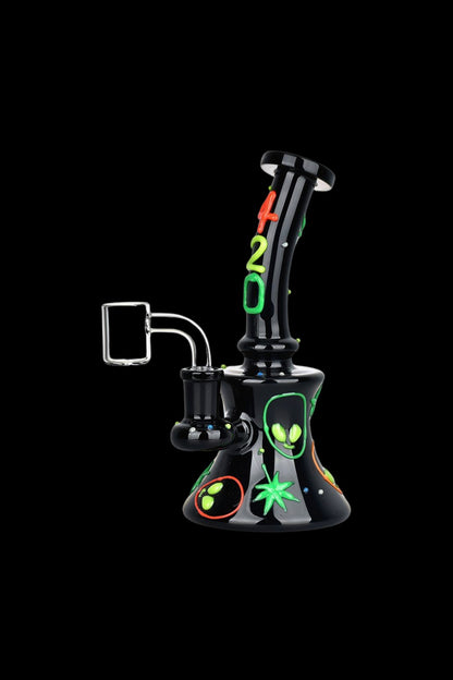 Black glass water pipe with alien-themed decals and green accents, isolated on a black background.