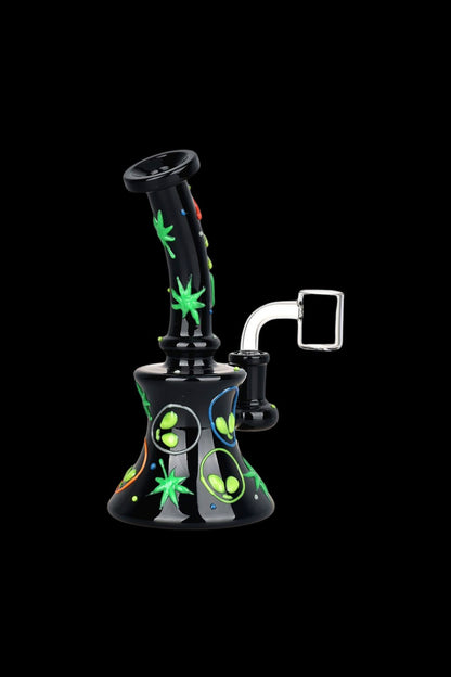 Black glass bong with vibrant green and colorful alien-themed decals, featuring a curved neck and accompanying glass bowl.