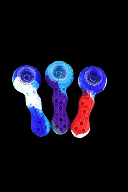 Colorful silicone smoking pipes against a black background.