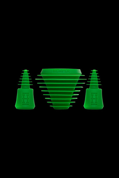Green silicone hash rosin press pucks and collection funnel isolated on a black background.
