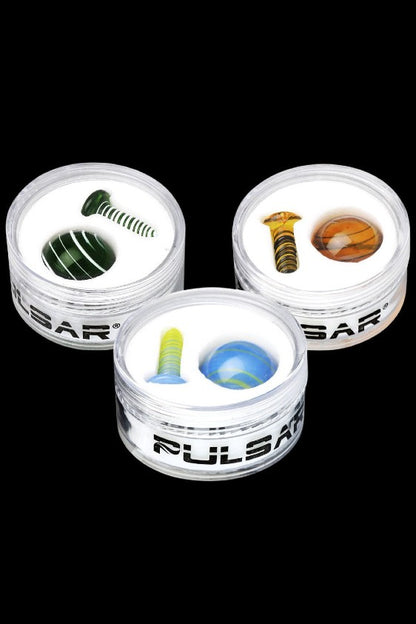 Four Pulsar glass smoking bubblers with various colorful inserts displayed against a black background.