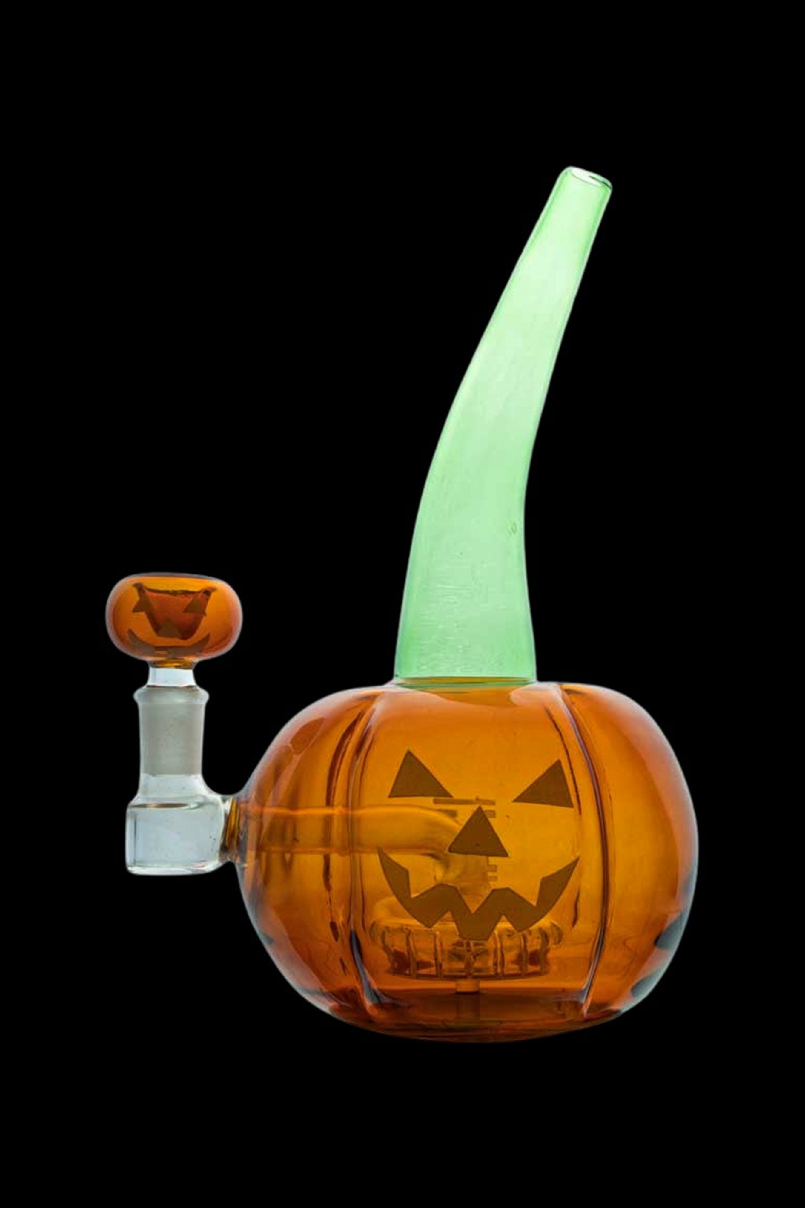 Glass pumpkin-shaped water pipe with glowing green accents.