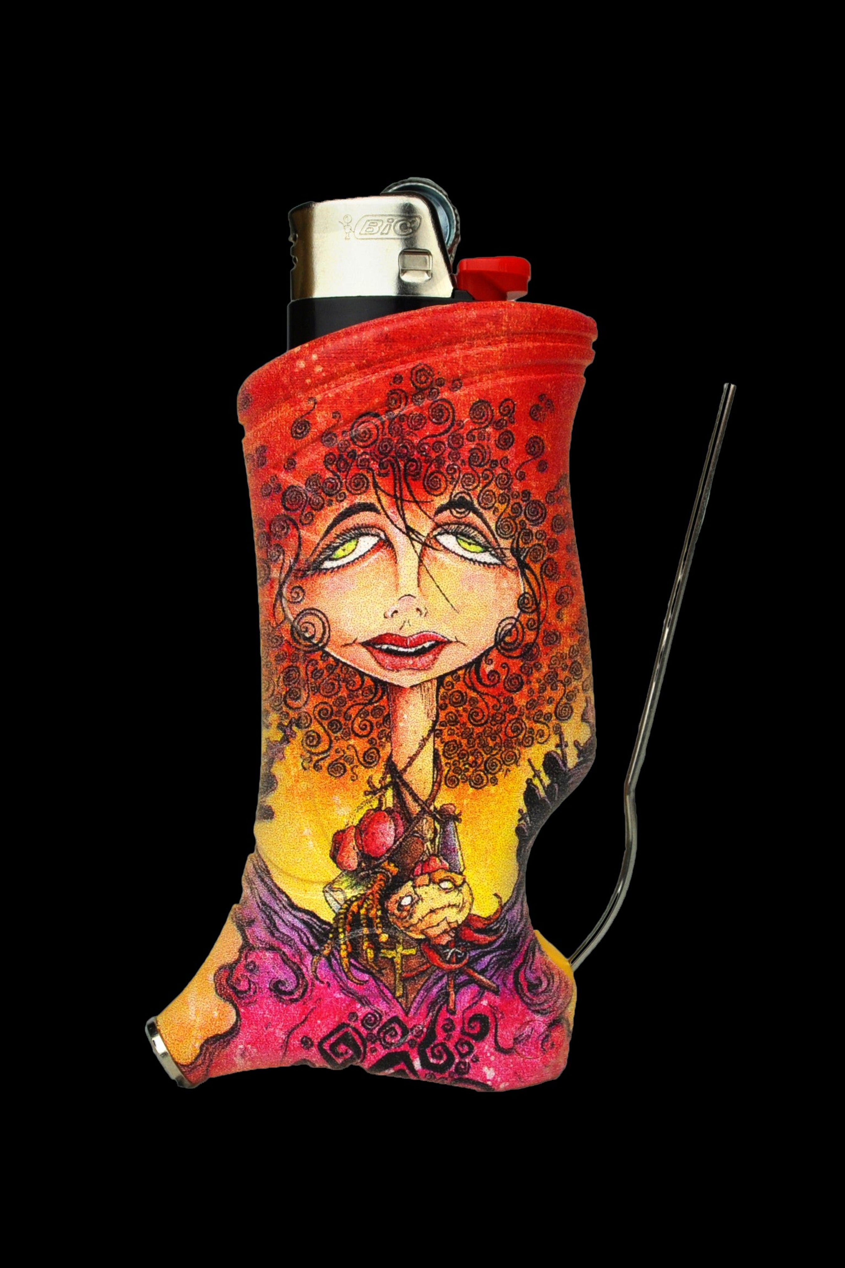 A colorful, patterned cozy sleeve covers a lighter, with a glass smoking tool alongside, against a black background.