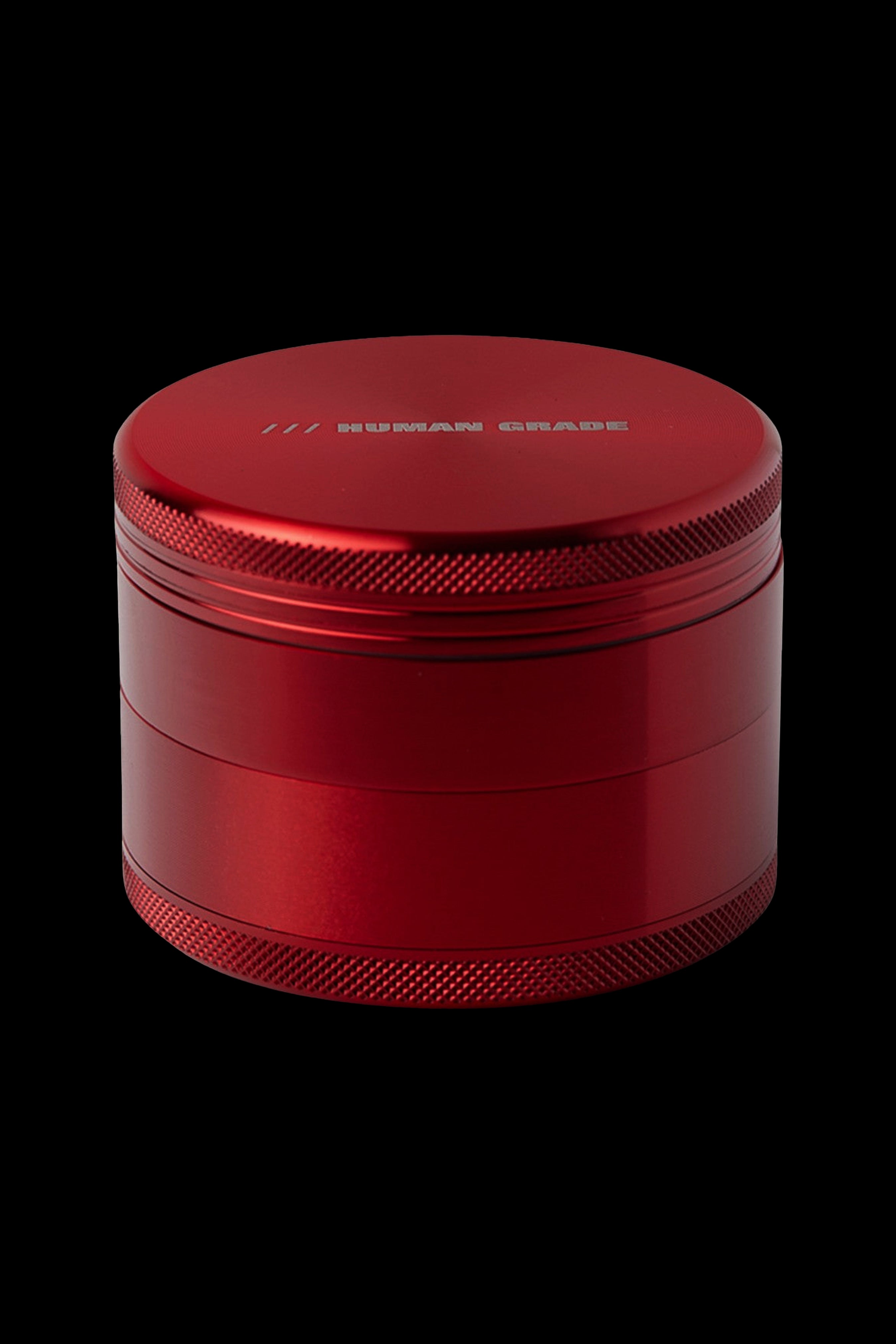 Red four-piece metal cannabis grinder.