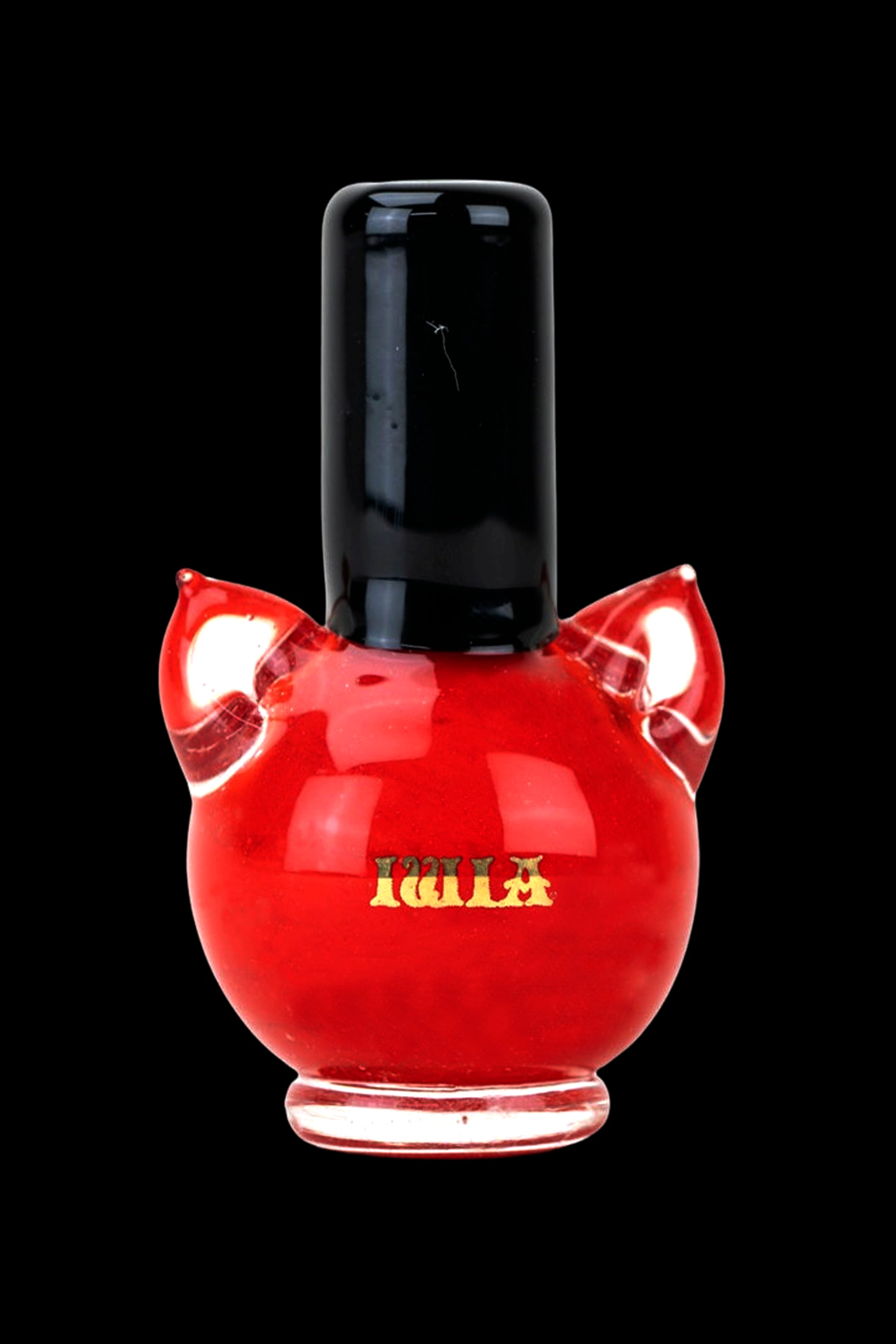 Red glass cannabis oil bottle with gold lettering against a black background.