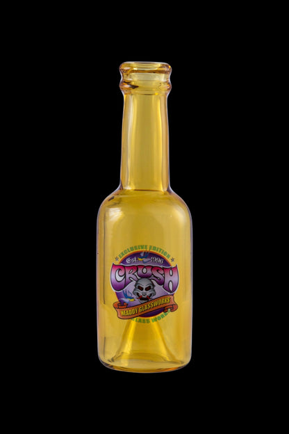 A vintage glass oil bottle labeled “Headdy Glassworks Est. 1996” with colorful psychedelic graphics.