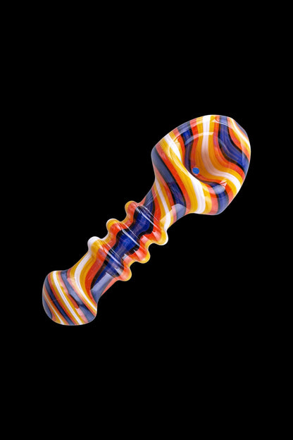 Colorful glass dab rig against a black background.