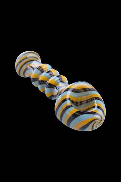 Hand-blown glass bubbler with swirling blue, yellow, and black stripes.