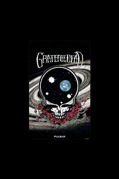 Grateful Dead-inspired cannabis packaging featuring a skull with a swirling galaxy and red roses, branded with “Pulsar.”