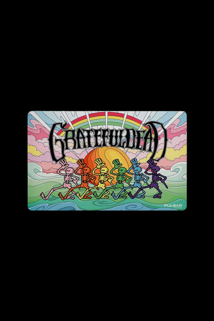 Retro-style illustration of dancing skeletons under a sunset with “Grateful Dead” text above, branded with “Pulsar” logo.