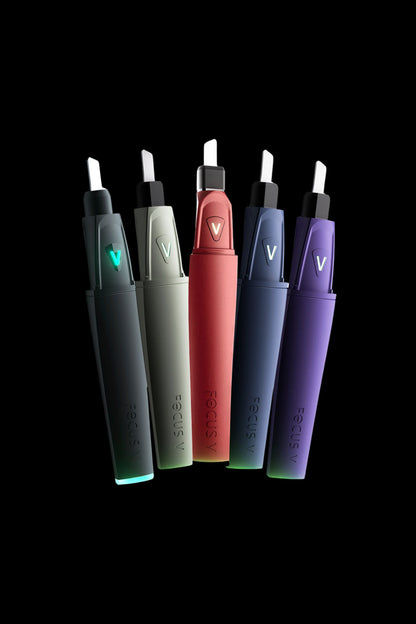 A lineup of sleek, pen-style cannabis vaporizers in shades of teal, red, black, and purple, branded with “FOCUS V”.