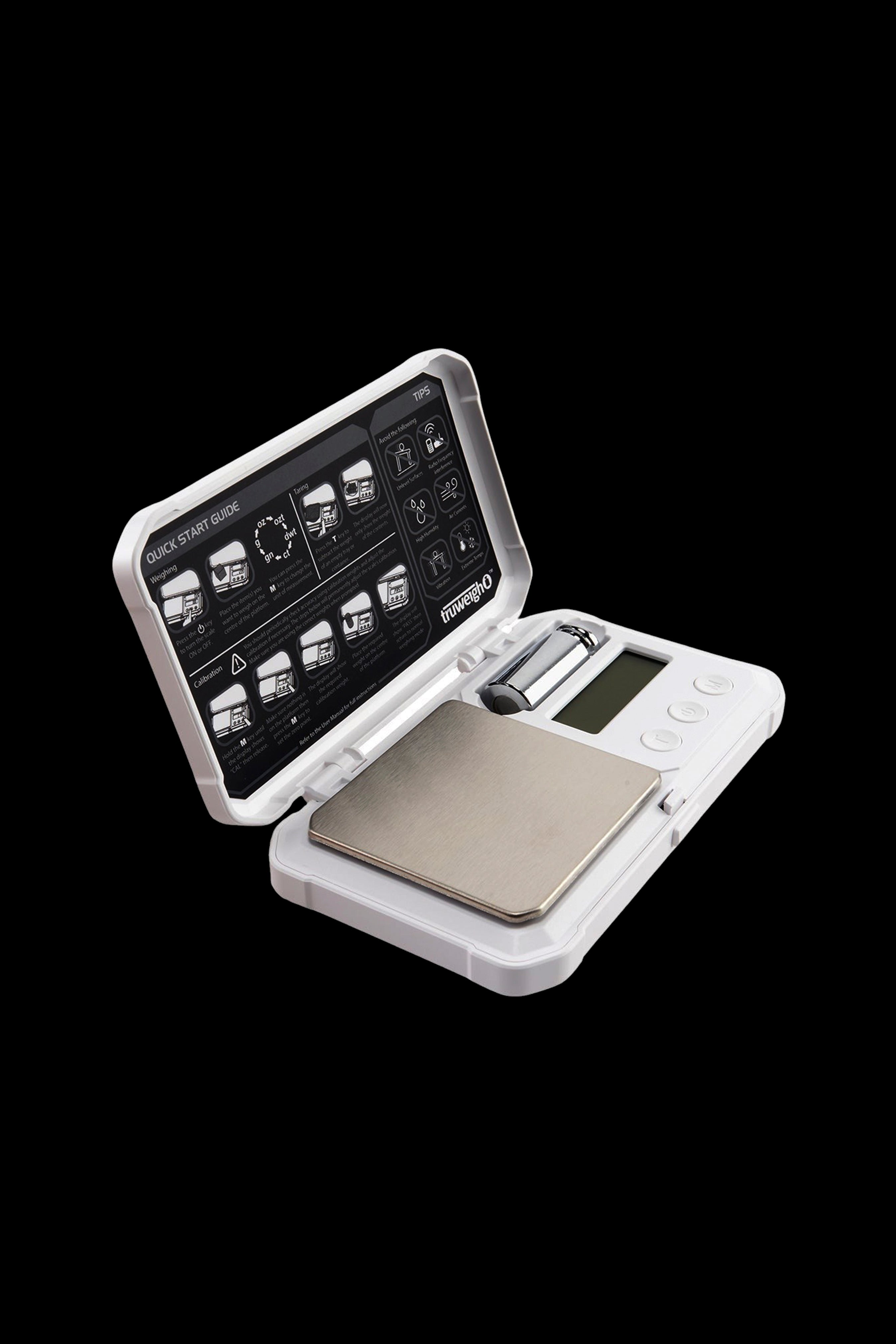 Digital scale with open lid displaying instructions, likely for measuring cannabis.