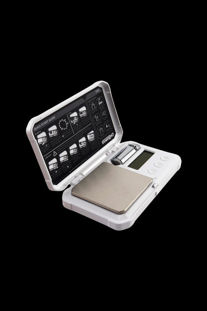 Digital scale with open lid displaying instructions, likely for measuring cannabis.