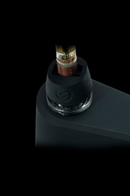 Cannabis oil cartridge inserted into a sleek, black vaporizer device.