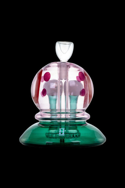 Hand-blown glass bubbler with pink polka dots and a green base.