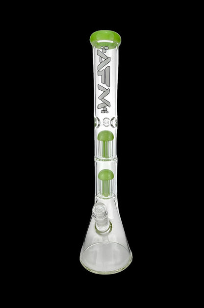 Clear glass bong with green accents and multiple filtration chambers.