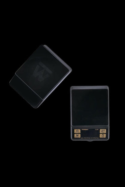 Black digital scale with a reflective surface, often used for measuring cannabis.