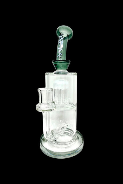 A clear glass water pipe (bong) with a green mouthpiece and percolator filtration system.