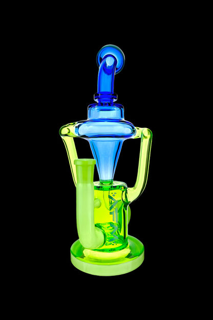 A vibrant green and blue glass dab rig with intricate curves and a visible water chamber, isolated on a black background.